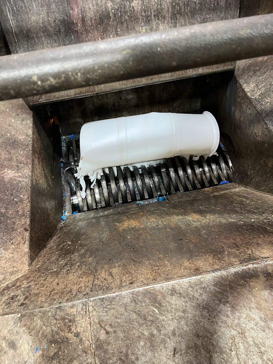 Toll grinder grinding a plastic container